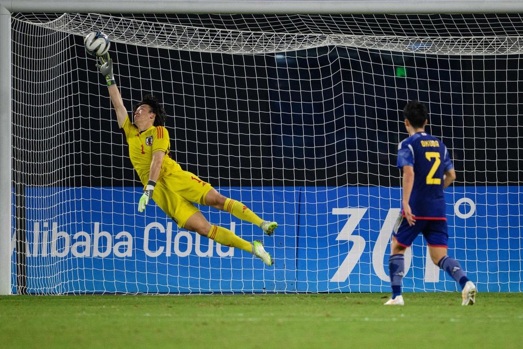 Kiper Jepang, Kazuki Fujita, mencoba menepis bola saat menghadapi Korea Selatan pada babak perempat final sepak bola putra Asian Games 2022 di Hangzhou, Minggu (1/10/2023).