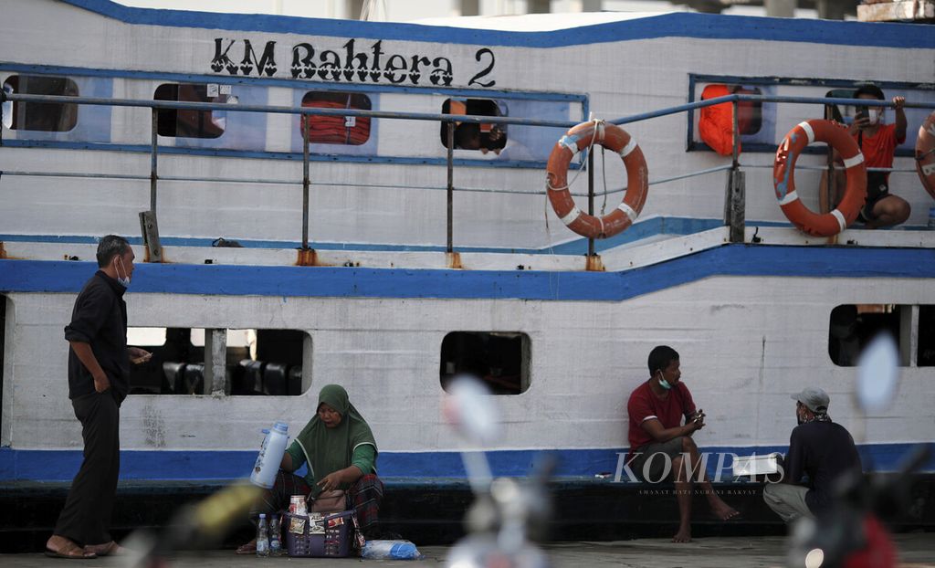ILUSTRASI. Penjual minuman melayani penumpang KM Bahtera 2 di Pelabuhan Kali Adem, Penjaringan, Jakarta Utara, Minggu (30/5/2021).