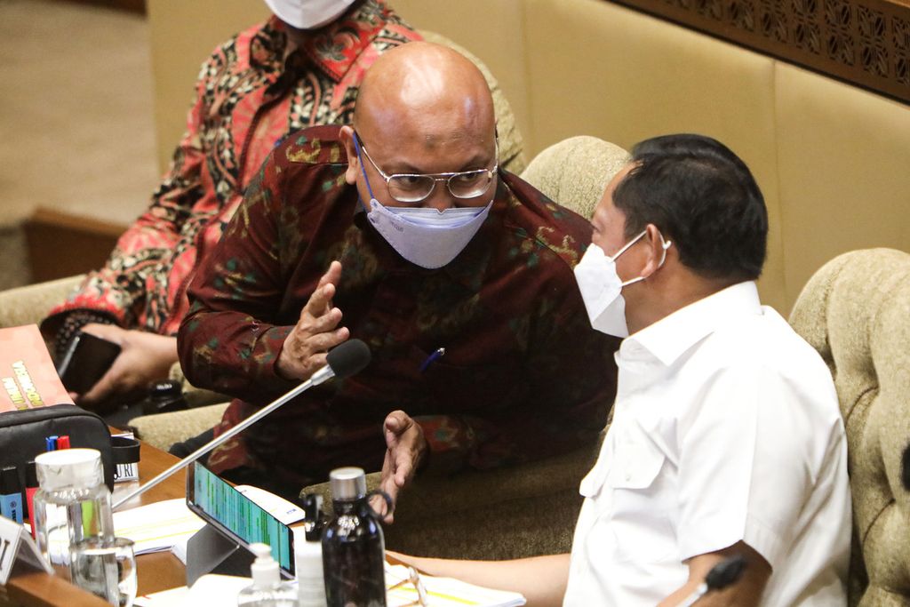Ketua KPU Ilham Saputra (kiri) berbincang dengan Menteri Dalam Negeri Tito Karnavian di sela-sela rapat kerja dengan Komisi II DPR membahas persiapan dan kesiapan pelaksanaan Pemilu serentak 2024 di Kompleks Gedung Parlemen, Senayan, Jakarta, Kamis (16/9/2021). Pembahasan antara lain terkait tanggal pelaksanaan pemilu dan anggaran pemilu. 