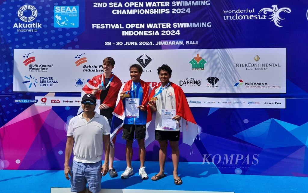 Indonesia menjadi tuan rumah 2nd Southeast Asia Open Water Swimming Championship (SEA OWS). Kejuaraan renang perairan terbuka digelar di Pantai Jimbaran, Badung, Bali, pada 28-30 Juni 2024. Wakil Ketua Umum PB Akuatik Indonesia Harlin Erlianto Rahardjo (depan, tengah) seusai memberikan medali dan piagam kepada juara lomba 2nd SEA OWS di Pantai Jimbaran, Badung, Jumat (28/6/2024)