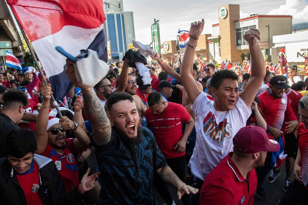 Costa Rican fans celebrate the victory in the Qatar 2022 World Cup Group E football match between Costa Rica and Japan in San Jose on November 27, 2022. 
