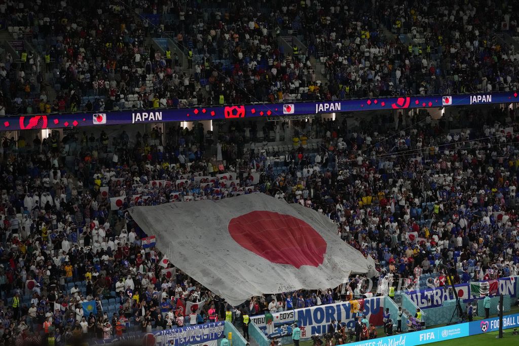 Bendera Jepang berukuran besar dibentangkan suporter jelang pertandingan babak 16 besar Piala Dunia 2022 antara Kroasia dan Jepang di Stadion Al Janoub, Qatar, Senin (5/12/2022). 