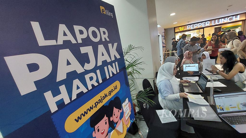 Petugas mendampingi wajib pajak mengisi data pelaporan SPT Tahunan PPh Orang Pribadi Tahun 2023 di Mal Kota Kasablanka, Jakarta Selatan, Minggu (31/3/2024).