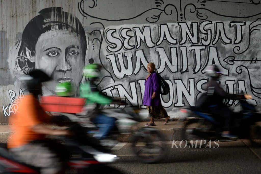 Warga melintasi mural Kartini di bawah jembatan layang Palmerah, Jakarta, Rabu (20/4/2016).  