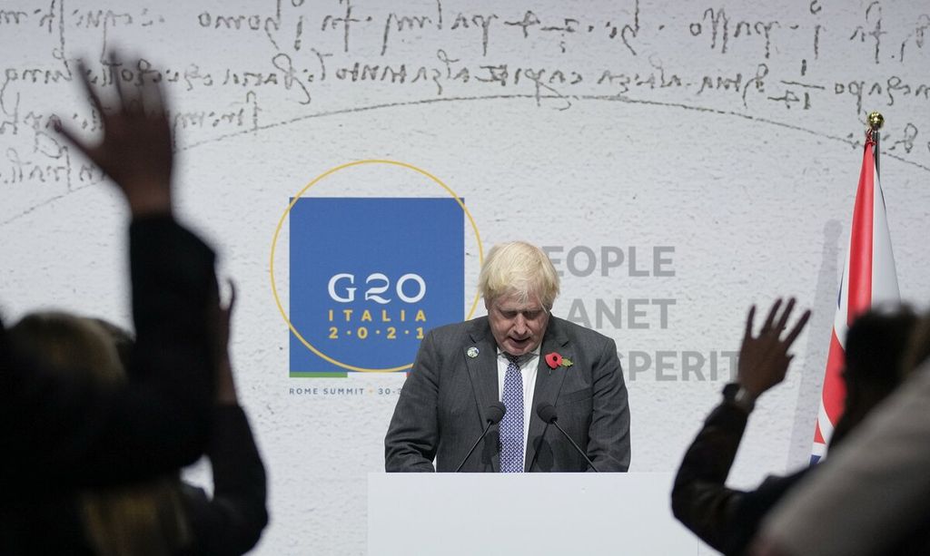 Journalist raise their hands to ask questions as British Prime Minister Boris Johnson speaks during a press conference at the La Nuvola conference center for the G20 summit in Rome, Sunday, Oct. 31, 2021. Leaders of the world's biggest economies made a compromise commitment Sunday to reach carbon neutrality "by or around mid-century" as they wrapped up a two-day summit that was laying the groundwork for the U.N. climate conference in Glasgow, Scotland. 