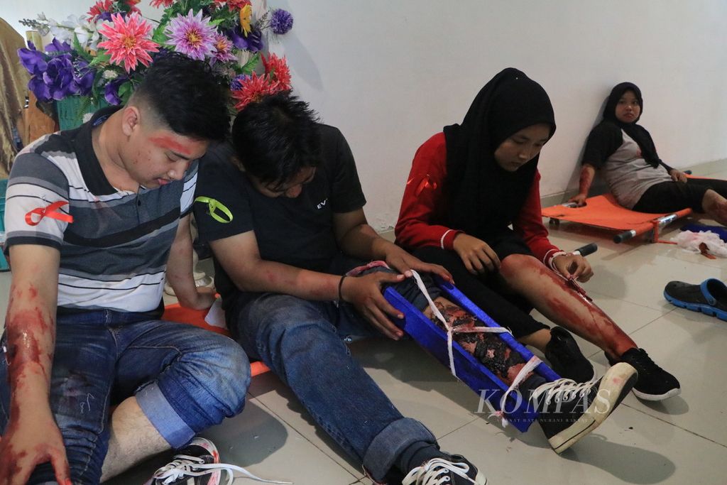 Penumpang pesawat udara yang terluka karena kecelakaan penerbangan dievakuasi dalam sebuah simulasi di Bandara Internasional Kualanamu, Kabupaten Deli Serdang, Sumatera Utara, Kamis (8/12/2022). 