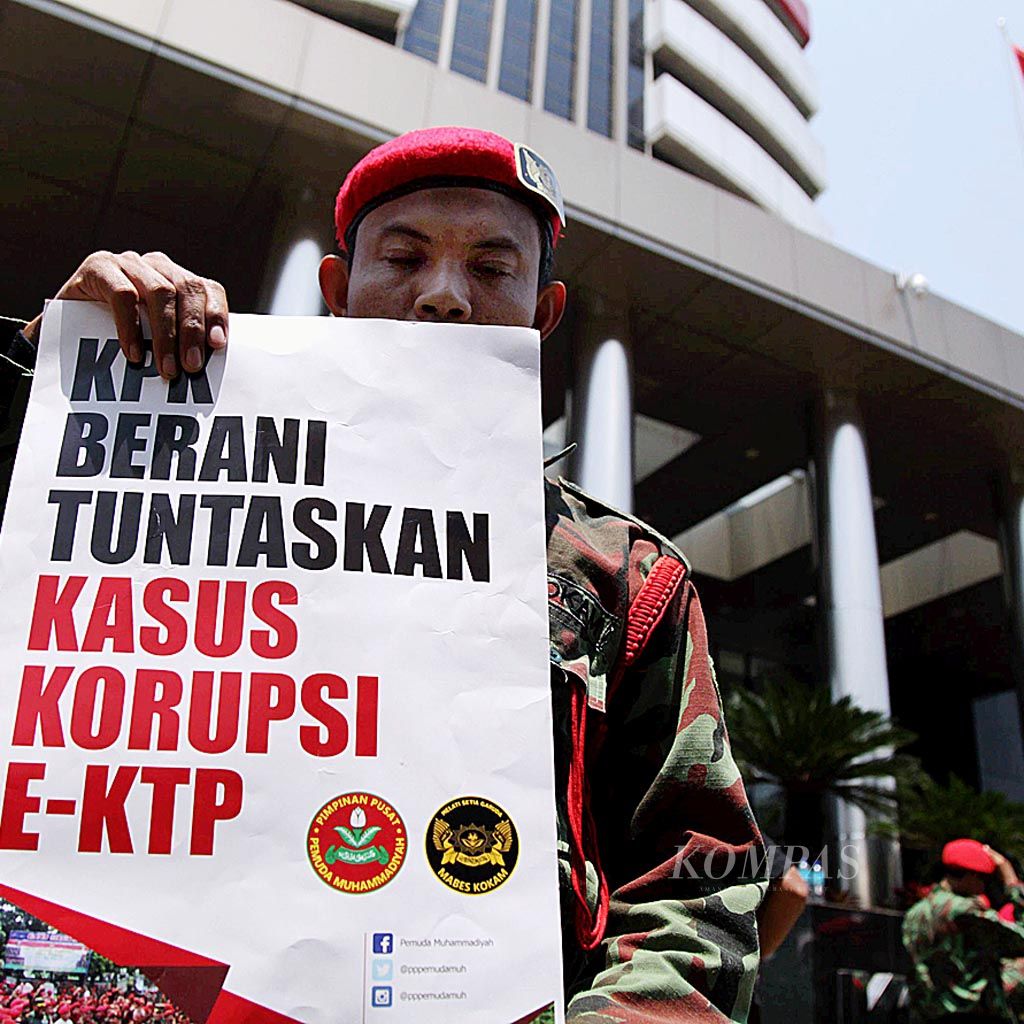 Anggota Komando Kesiapsiagaan Angkatan Muda Muhammadiyah mengangkat poster  saat menggelar aksi simpatik di depan kantor Komisi Pemberantasan Korupsi (KPK), Jakarta,  Jumat (24/3). Selain untuk mendukung KPK menuntaskan pengusutan korupsi KTP elektronik, aksi itu juga untuk menolak revisi Undang-Undang KPK.