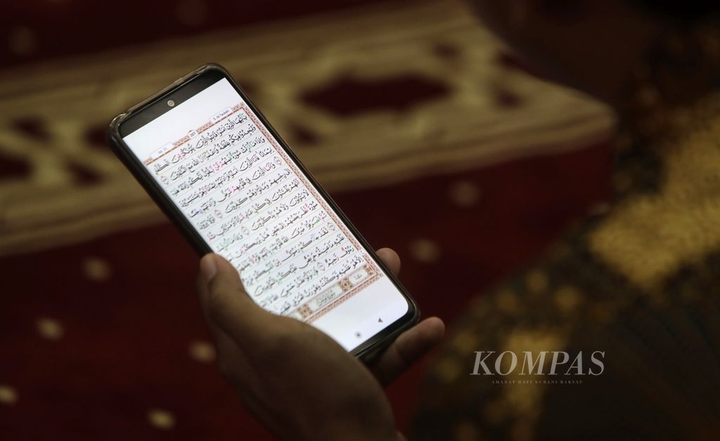 Muslims read the Quran through mobile applications in Istiqlal Mosque, Jakarta, on Friday (22/3/2024). One practical way to read the book is by using an application on a mobile phone.