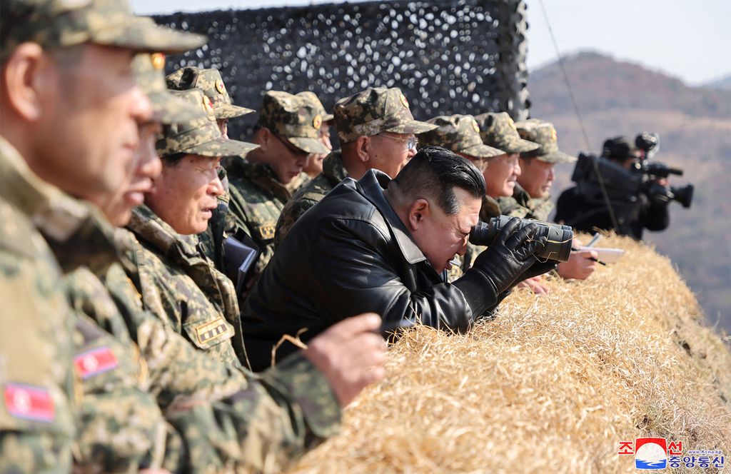 The photo taken on March 13, 2024 and released by North Korea's official news agency, KCNA, shows North Korean Leader Kim Jong Un (center) supervising military war exercises in a classified location.