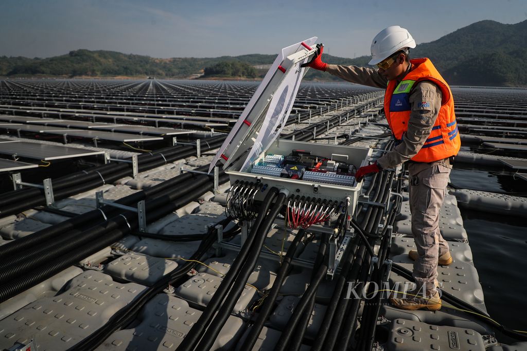 Teknisi memeriksa PV combiner box pada proyek PLTS Cirata di Purwakarta, Jawa Barat, Selasa (26/9/2023). PLTS terapung terbesar di Asia Tenggara ini berkapasitas 192 MWp dan mampu memproduksi 245 juta kWh energi bersih per tahun serta melistriki lebih dari 50.000 rumah. Dengan demikian, emisi karbon dapat ditekan hingga lebih dari 200.000 ton per tahun. KOMPAS/ADRYAN YOGA PARAMADWYA (YGA) 26-09-2023