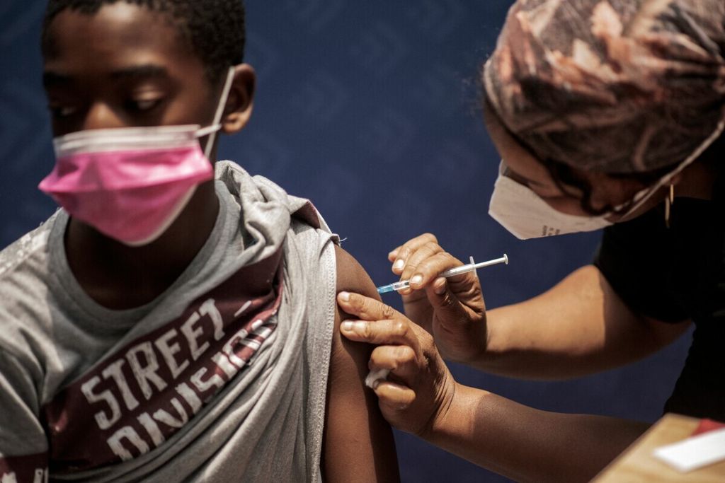 Anak laki-laki menerima suntikan vaksin Covid-19 di pusat vaksinasi Discovery di Sandton, Johannesburg, Afrika Selatan, 15 Desember 2021. 