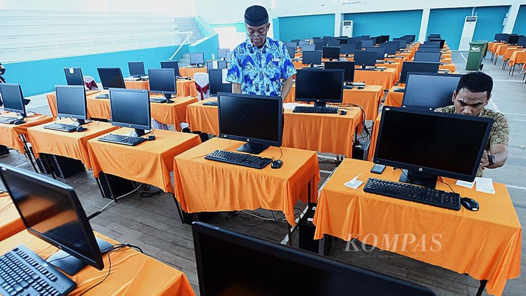 Petugas menyiapkan perangkat komputer untuk ujian CPNS Kota Surabaya di Gelanggang Remaja Tambaksari, Surabaya, Jumat (26/10/2018). 