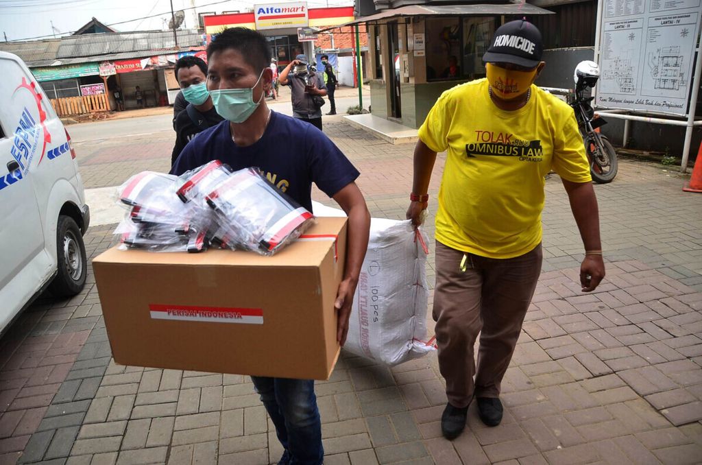 ndonesian workers, with one (R) wearing a shirt reading “reject omnibus law”, donate personal protective equipment (PPE) to a local hospital as part of their protest on May Day, or International Workers’ Day, in Bekasi, West Java on May 1, 2020. 
