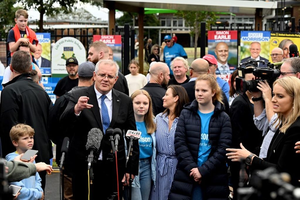Perdana Menteri Australia Scott Morrison (kiri) berbicara kepada pers bersama istrinya, Jenny, dan putri mereka setelah memberikan suara mereka di luar tempat pemungutan suara selama pemilu parlemen Australia di Sydney, Sabtu (21/5/2022).