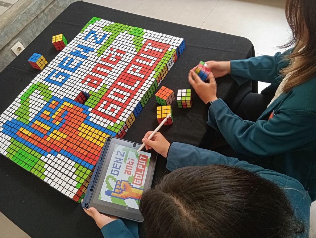 Two female students from the University of Surabaya assembled 150 Rubik's cubes as an installation for a campaign targeting voters, especially the Z generation, to use their voting rights in the general election on February 14, 2024.