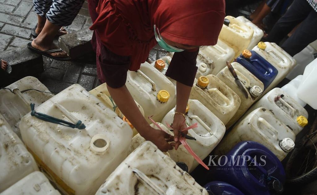 Warga memberi tanda jerikennya saat antre dalam operasi pasar minyak goreng curah untuk pedagang di Pasar Tambakrejo, Kota Surabaya, Jawa Timur, Jumat (18/2/2022). Minyak goreng curah dalam operasi pasar tersebut dijual Rp 10.500 per liter. 